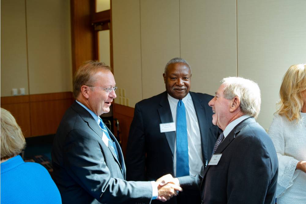Guests shaking hands at the Foundation Annual Meeting